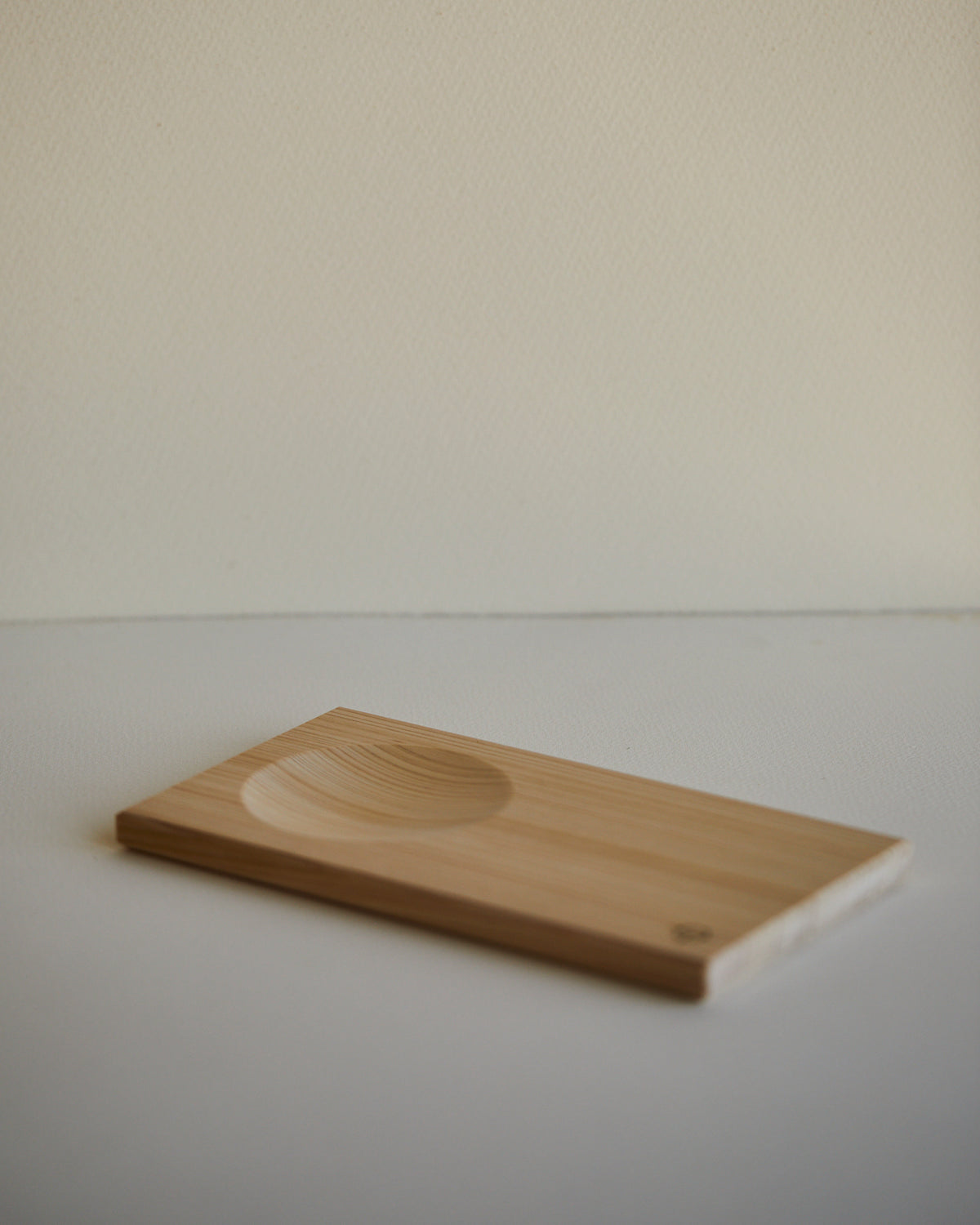 Hinoki sake serving tray with a single carved hollow, by Ted ODonnell